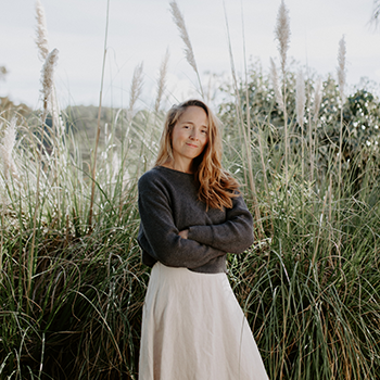 Image of a wedding photographer Ola Nadolna standing on the Algarve cliffs.